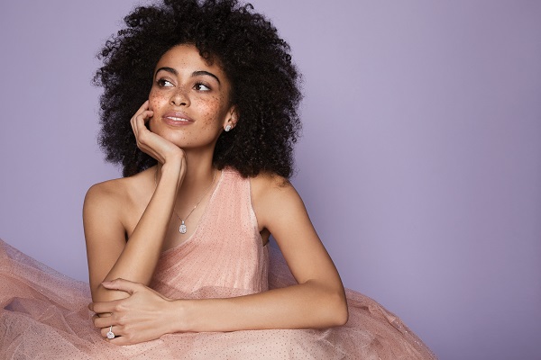 A woman in a formal dress wearing sparkly jewellery from Ernest Jones.