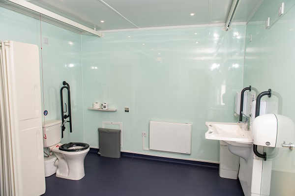 an area of the changing places facility with toilet and sink show plus a rail for the hoist