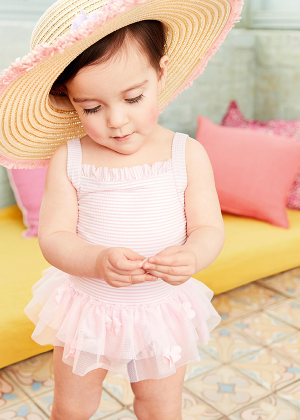 Young girl in straw hat and beachwear from Monsoon