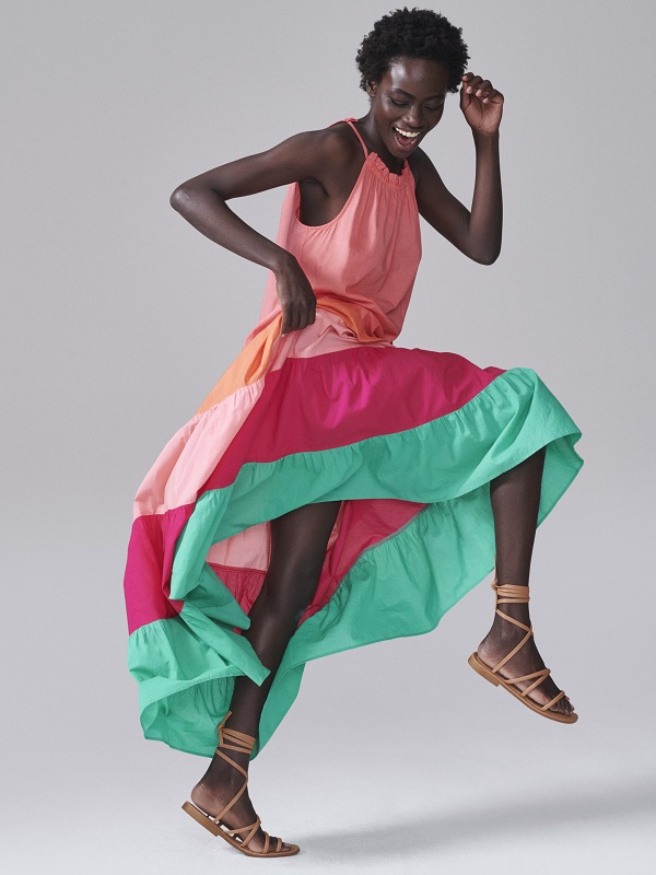 a model wearing a colourful dress
